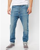 Asos Tapered Jeans In Mid Wash - Lyst
