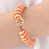 Tory Burch Dual Color Logo Beaded Bracelet in Gold - Lyst