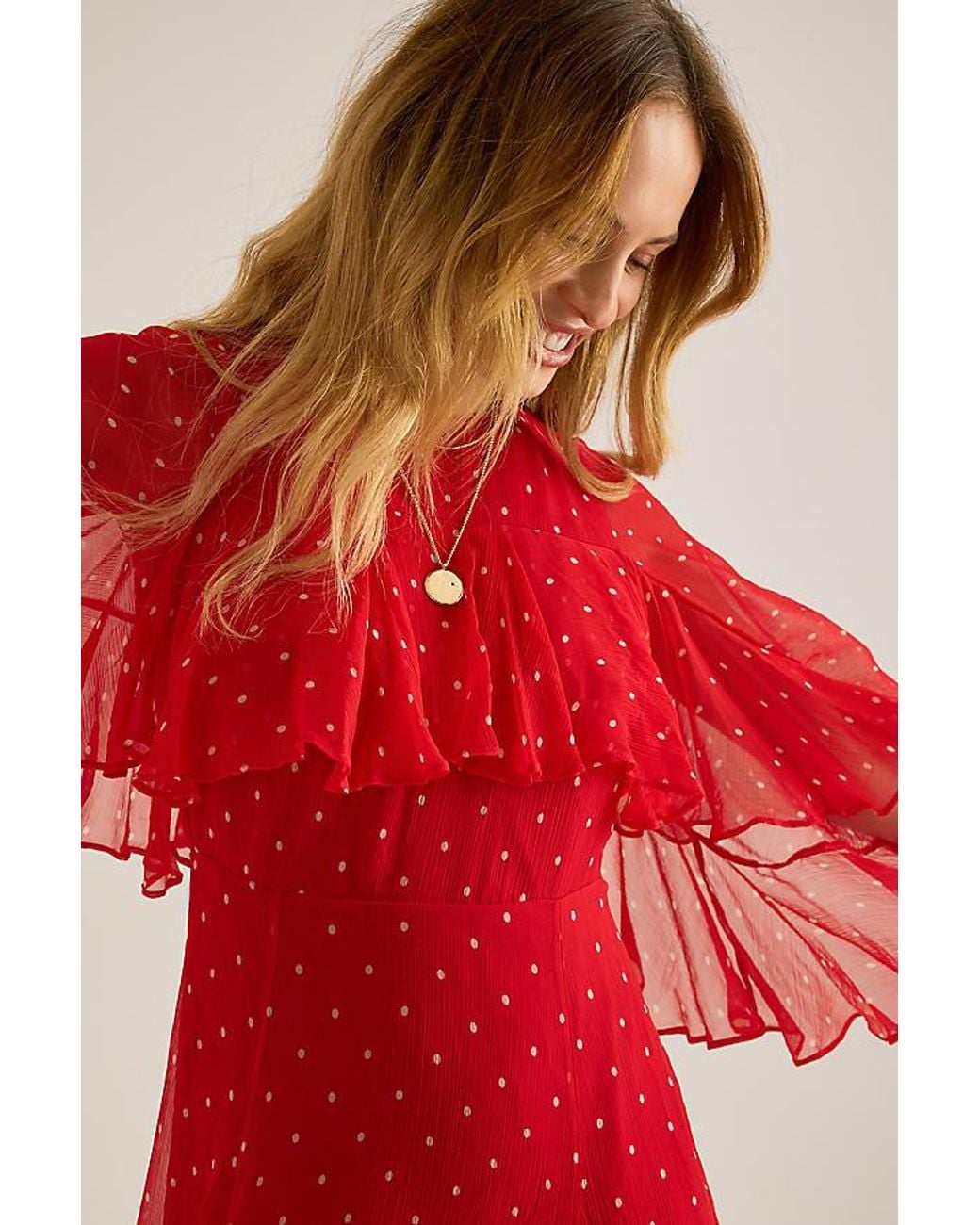queens of archive aria chiffon maxi dress Meet Aria, The Scarlet Siren  A dress that dances between vintage glamour  and untamed allure. Drenched in fiery red and scattered with playful polka  dots, this caped-sleeve maxi is a love