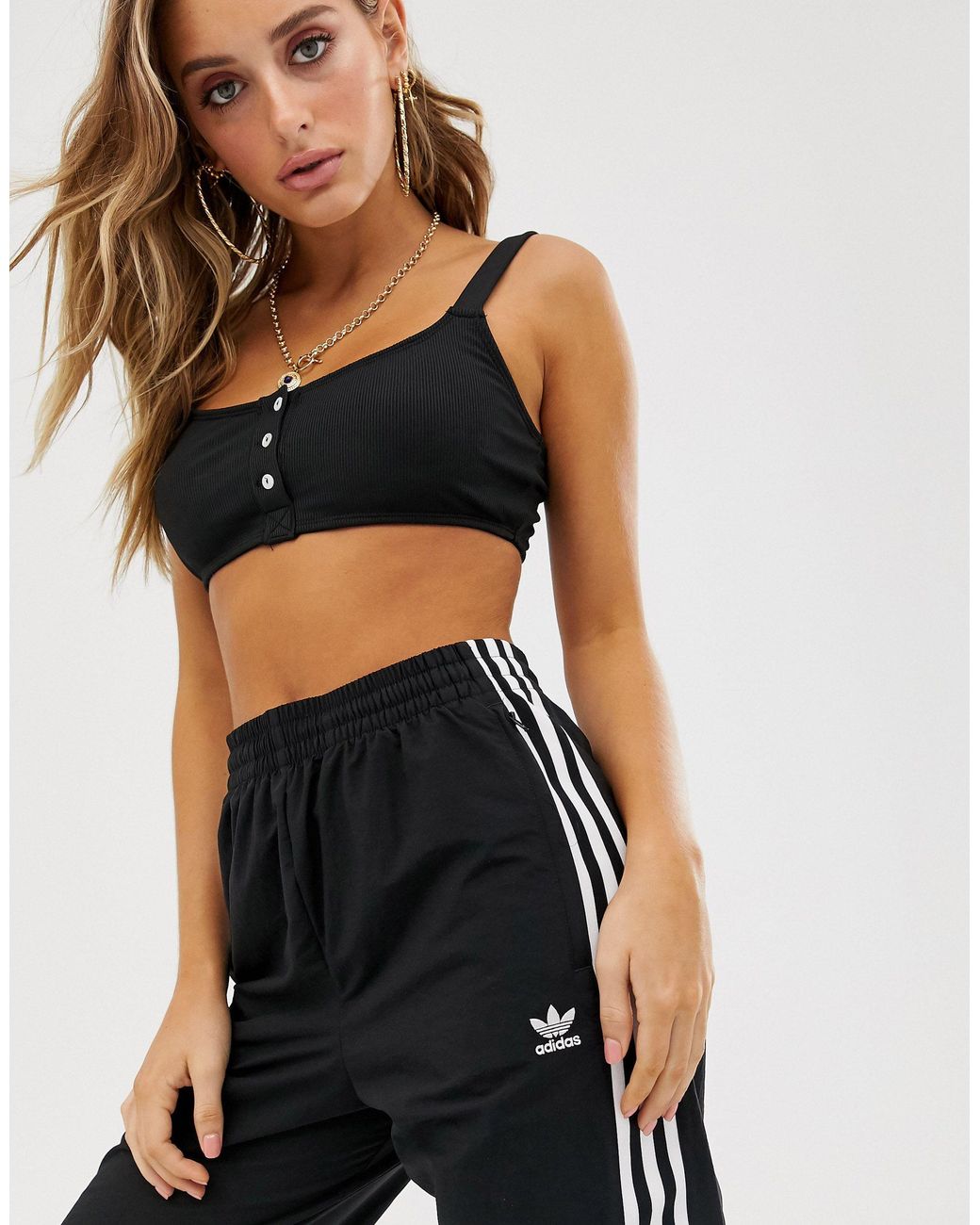 Adidas originals adicolor locked up logo track pants in black Clearance