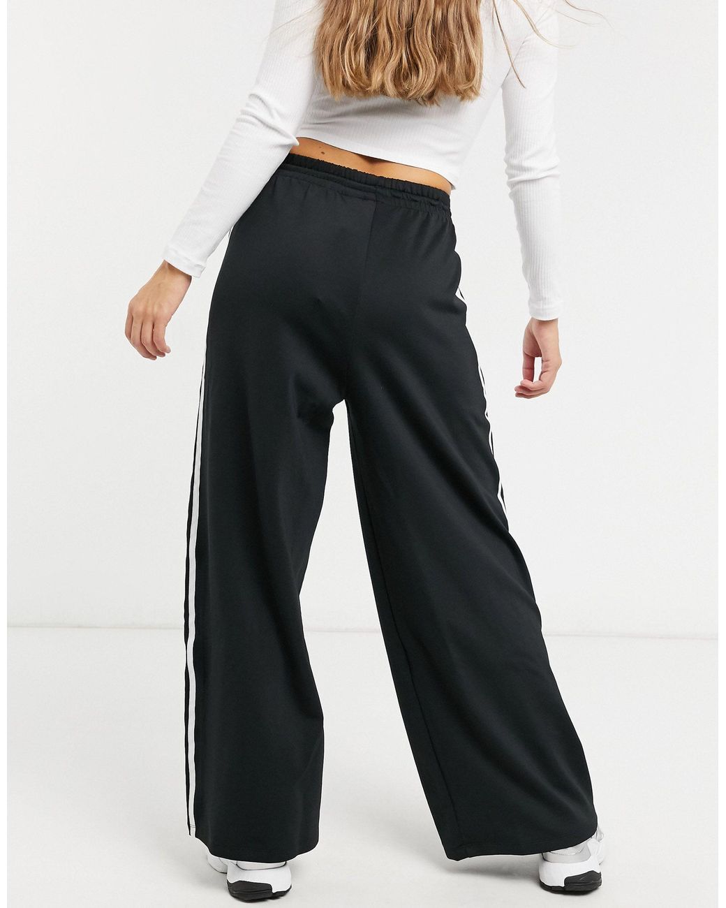 adidas originals adicolor three stripe flared pants in black