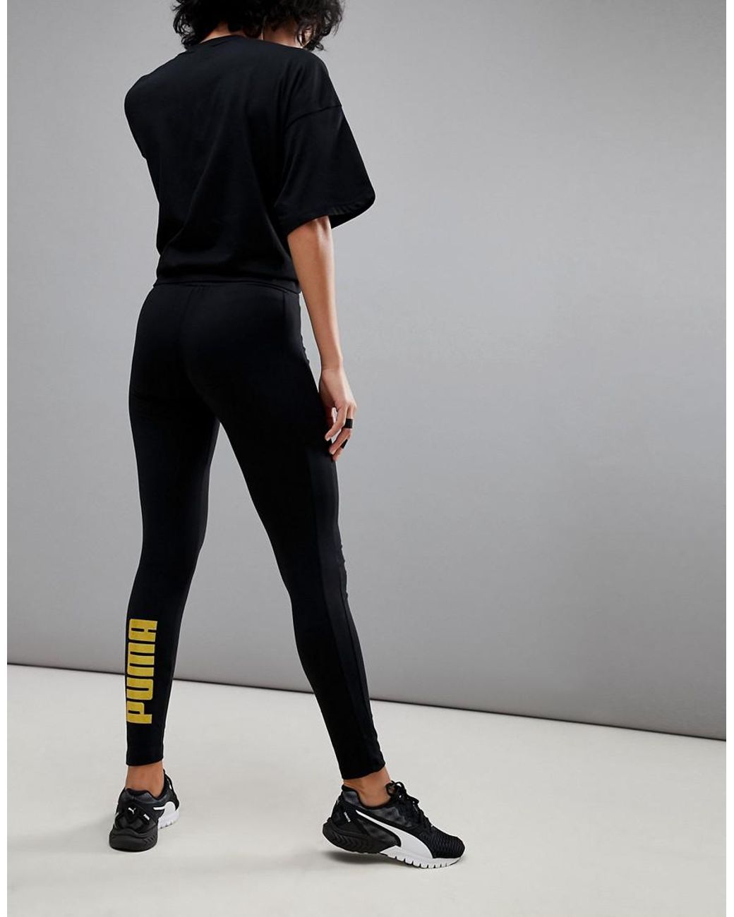 PUMA Leggings With Gold Logo in Black | Lyst