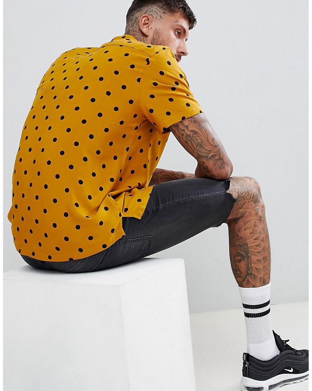 yellow and black polka dot shirt