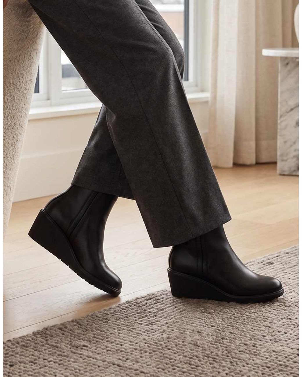 SEQWL Black Wedge Heel Ankle Booties With Cleated Sole And Pull Tab