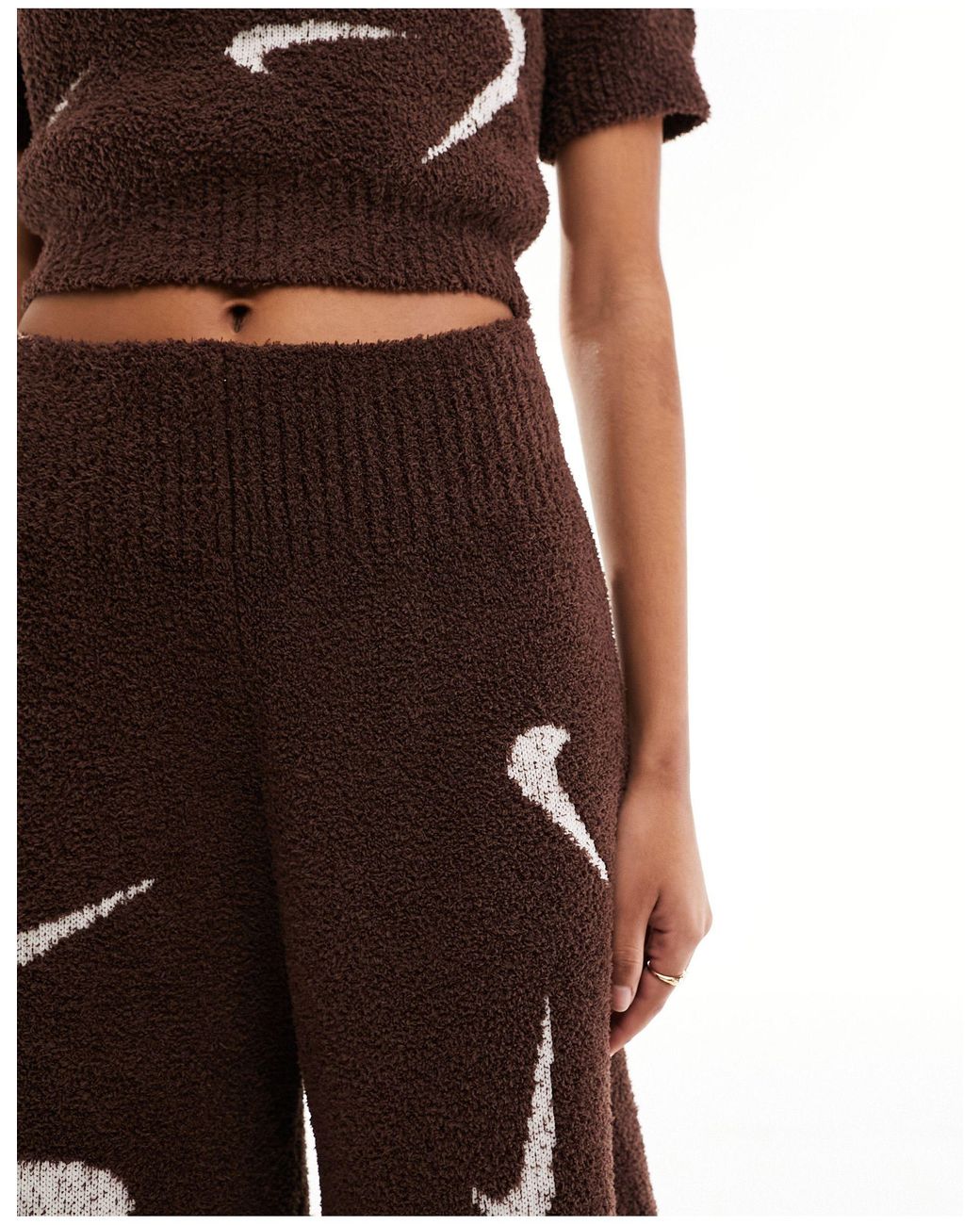 nike sweatpants with swoosh all over