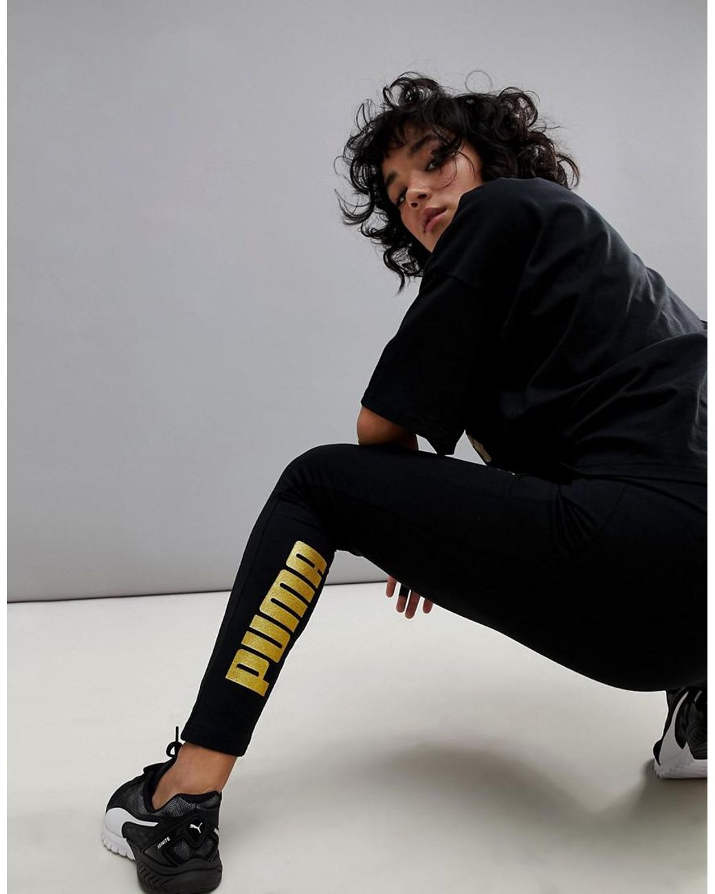 PUMA Leggings With Gold Logo in Black | Lyst