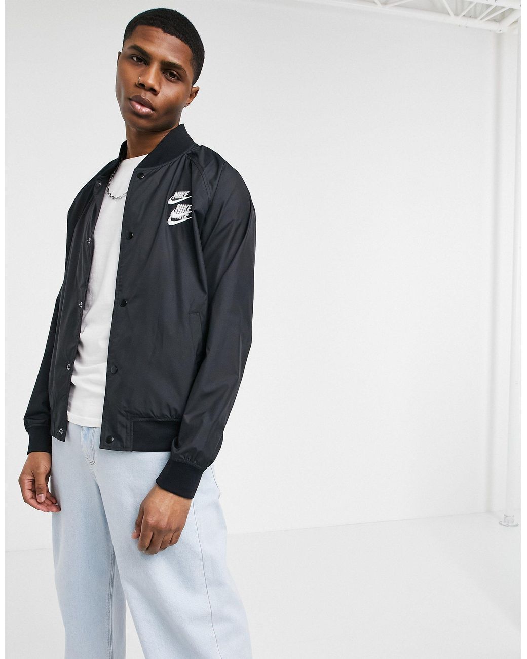 Nike World Tour Pack Graphic Woven Bomber Jacket in Black for