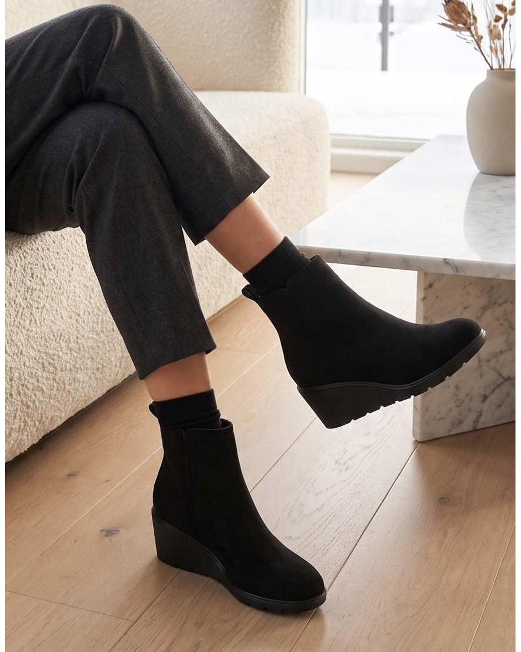 SEQWL Black Wedge Heel Ankle Booties With Cleated Sole And Pull Tab