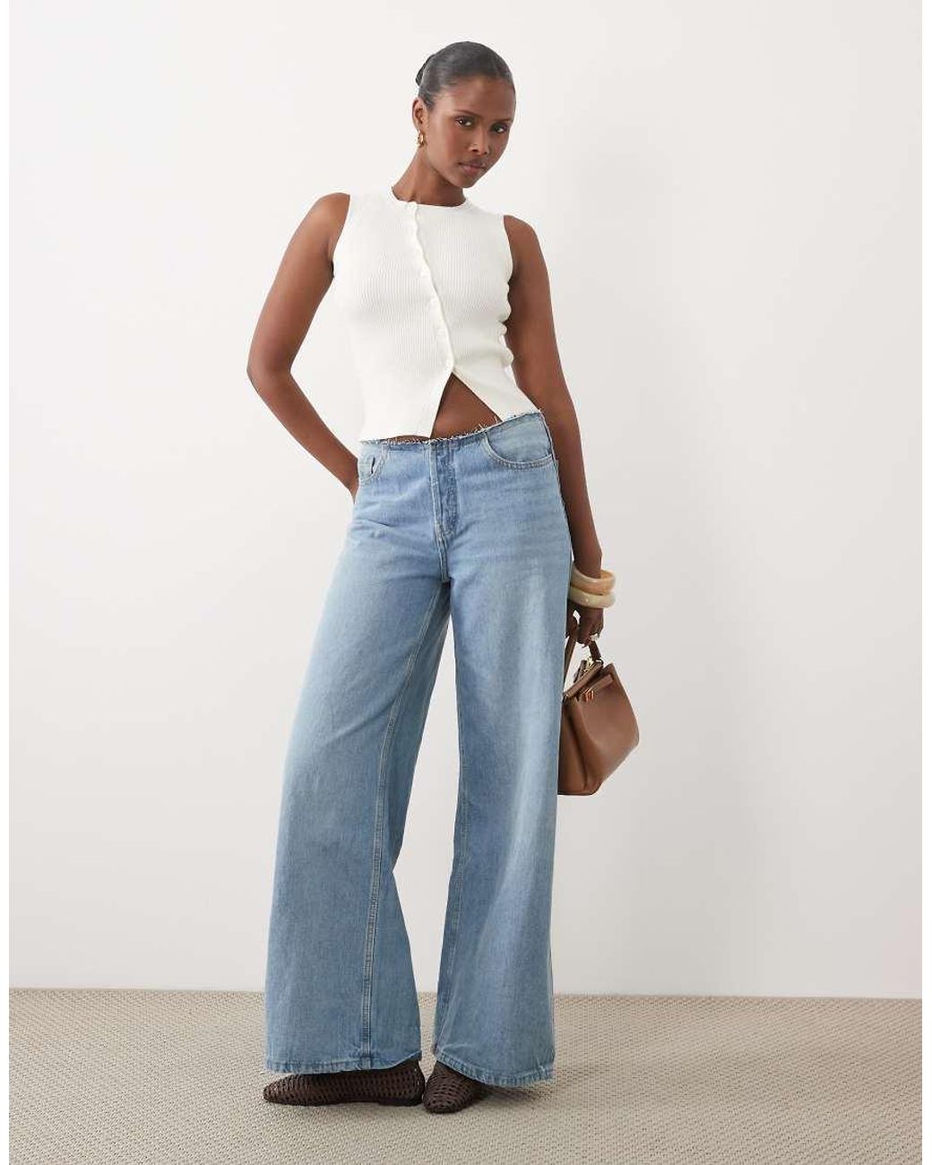The Frolic Blue Exclusive Sleeveless Asymmetric Button Knitted Top