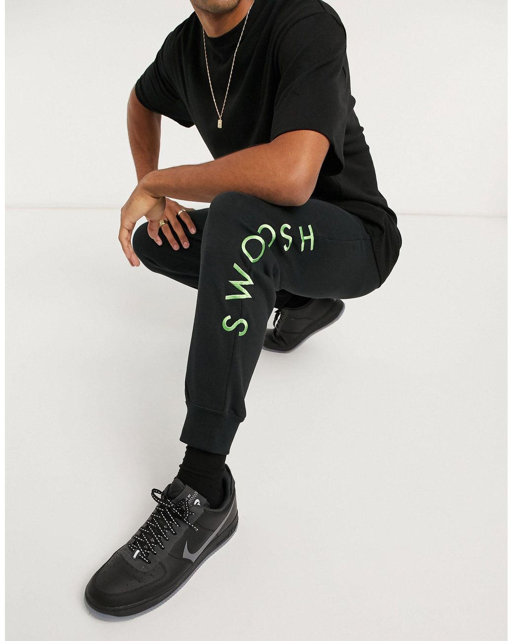Nike Swoosh Cuffed Sweatpants in Black for Men | Lyst