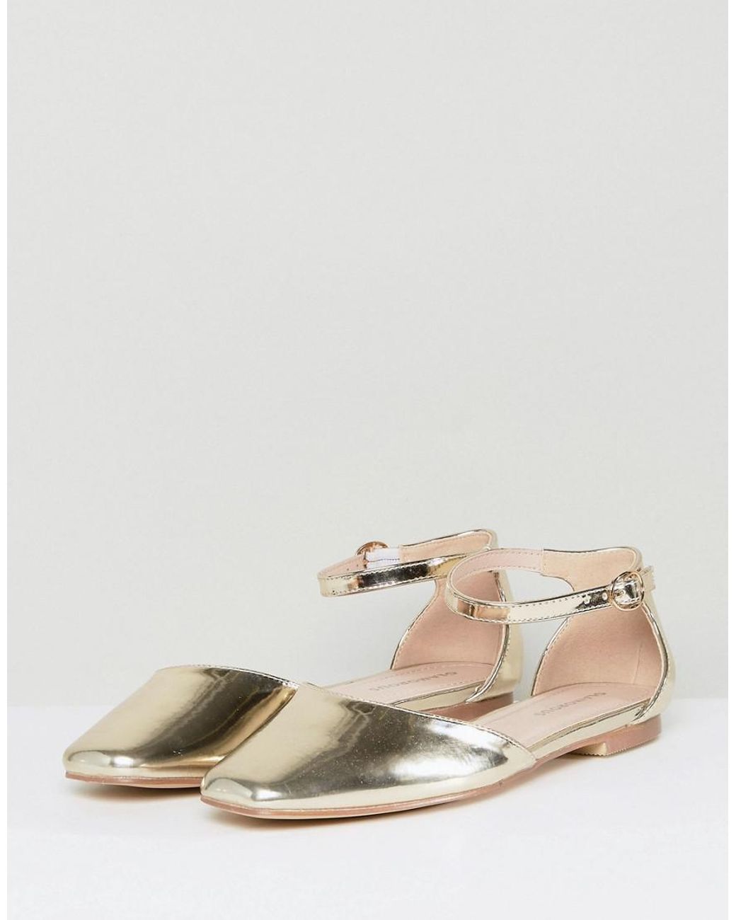 Black flats with top gold ankle strap