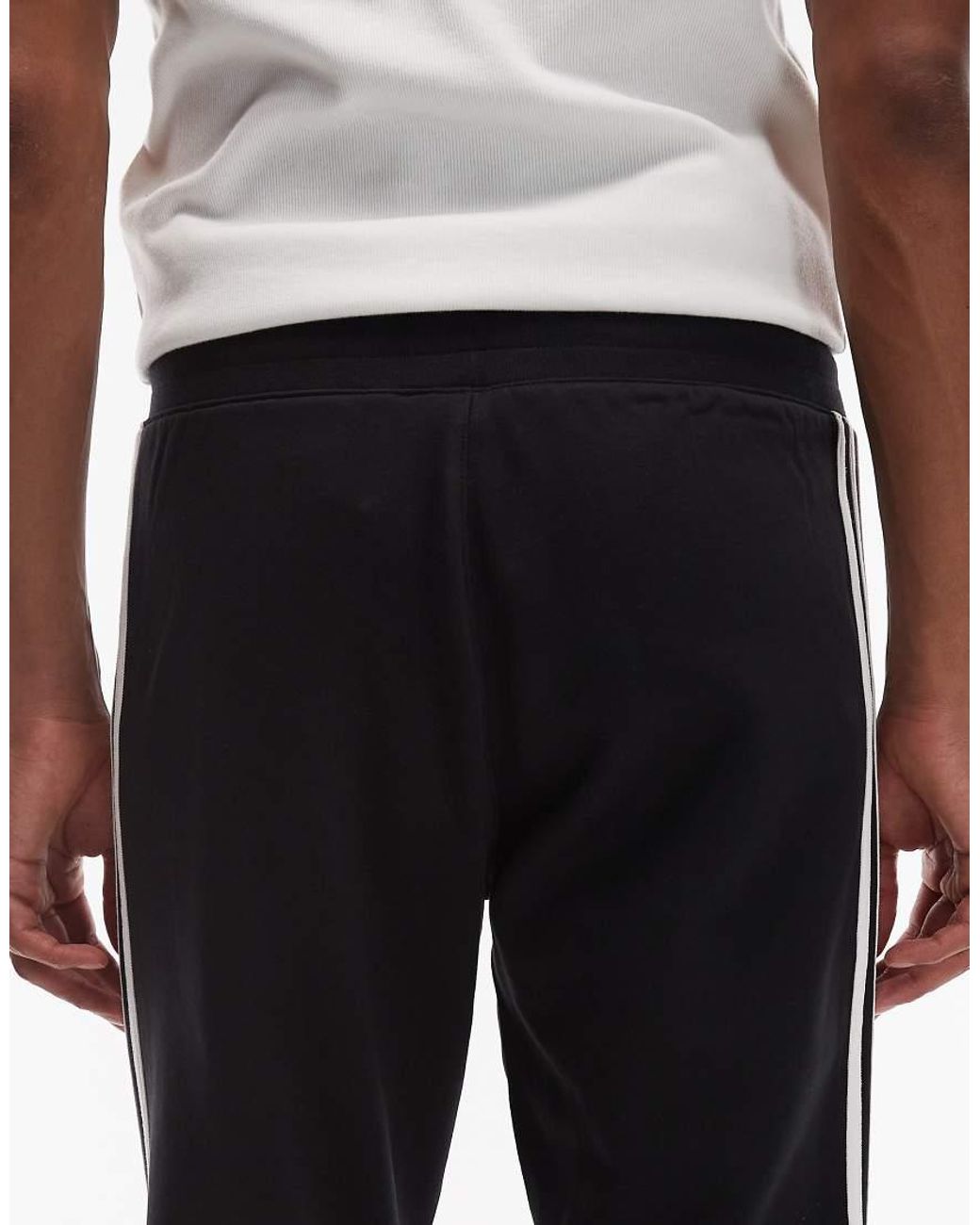 Adidas Originals Blue Three Stripe joggers for men