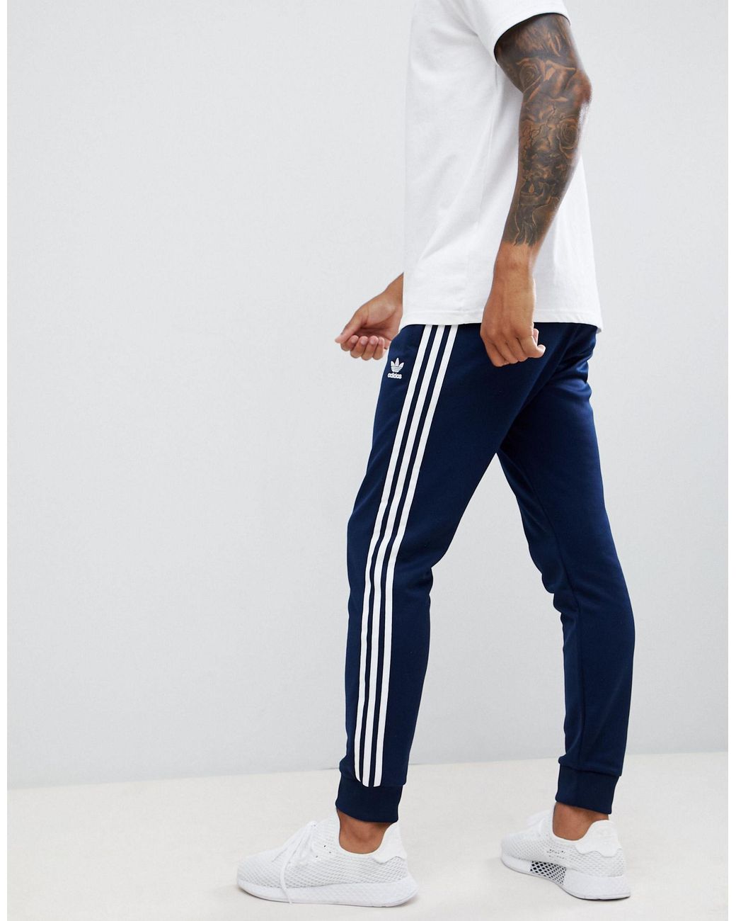 adidas Originals Three Stripe Skinny Sweatpants With Cuffed Hem in Blue for  Men | Lyst