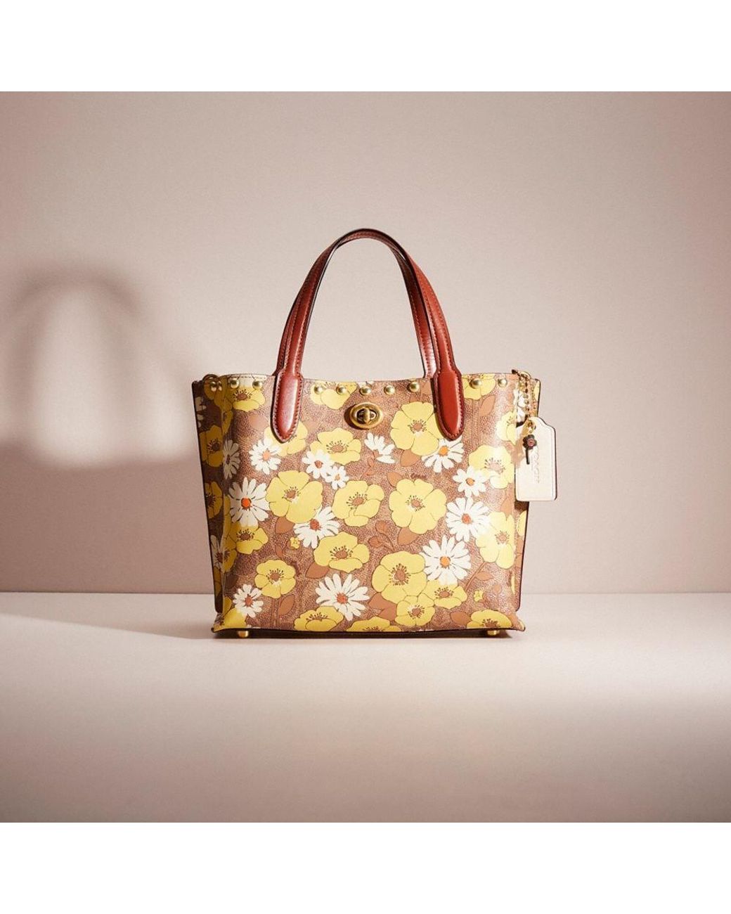 Buy the Coach Pink Signature Pattern Canvas Tote Bag Flower Charm