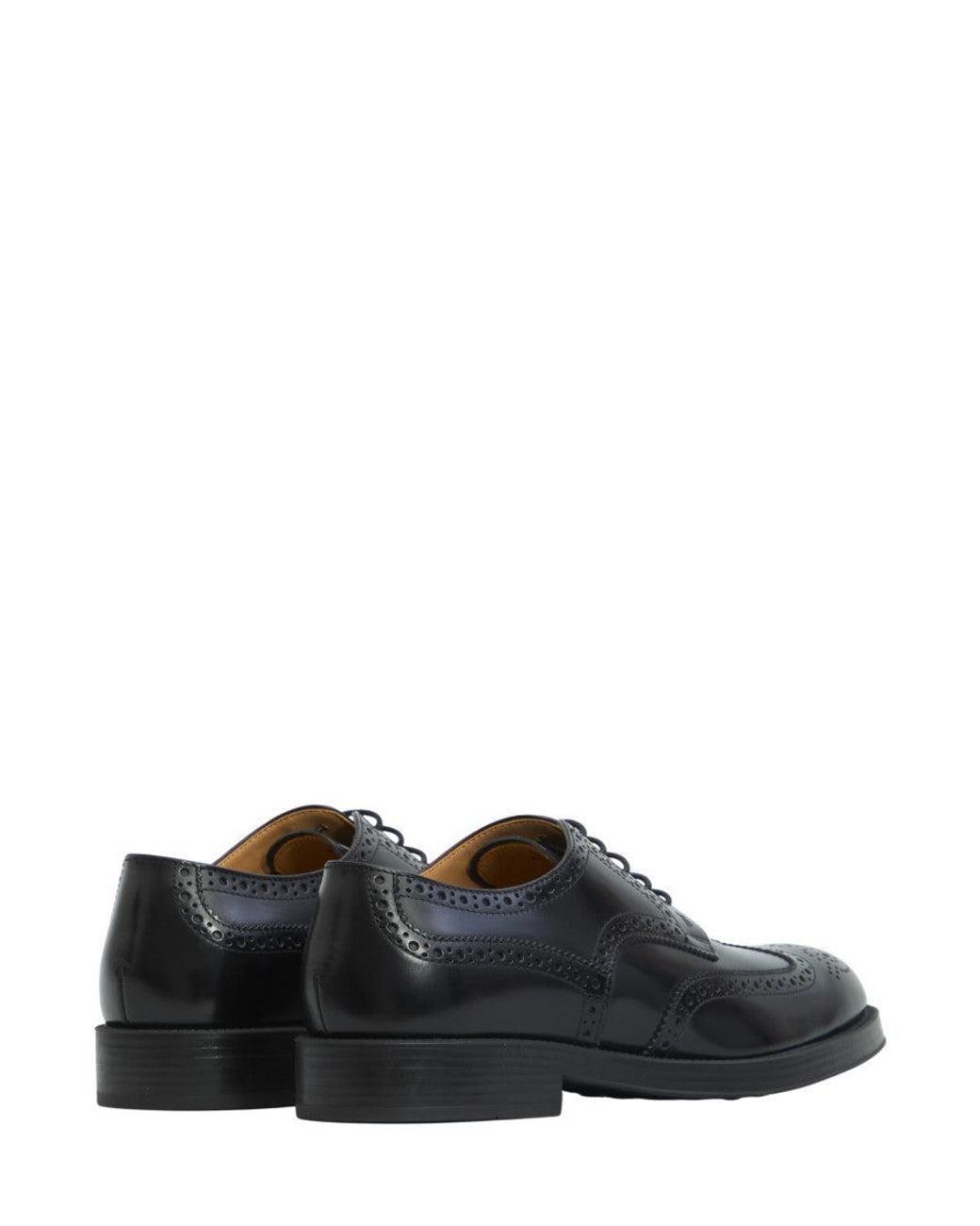 Tod's Black Perforated Wingtip Lace Ups Shoes for men