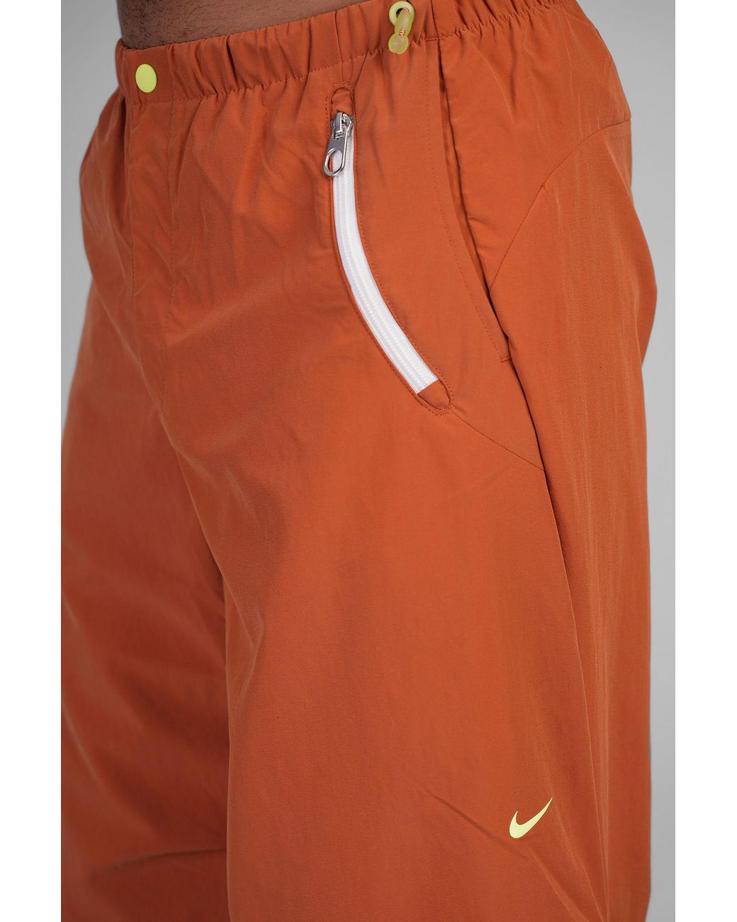 orange nike track pants
