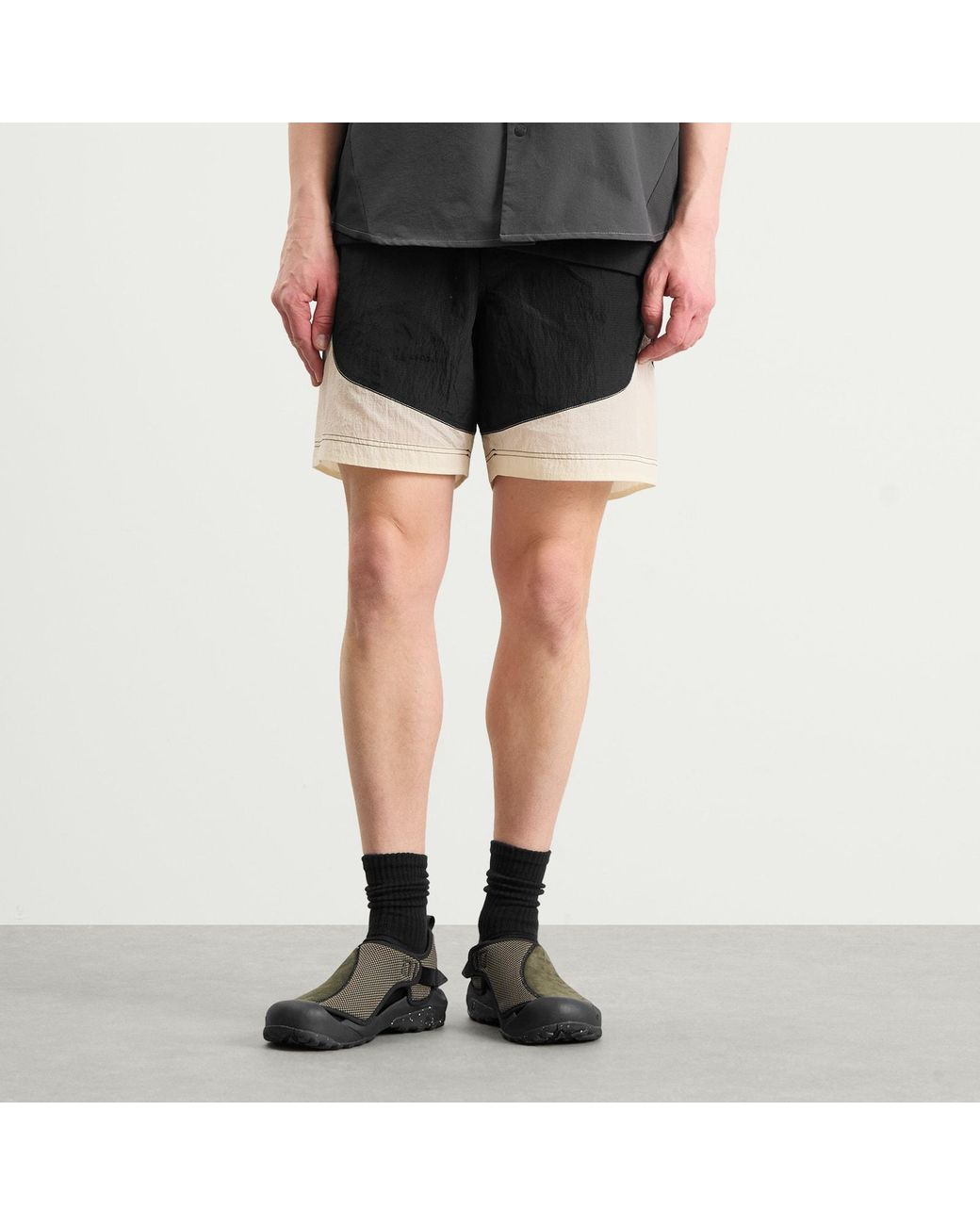 And Wander Black X Roa Ripstop Wind Shorts for men
