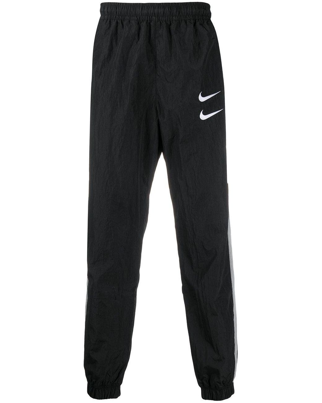 nike swoosh track bottoms