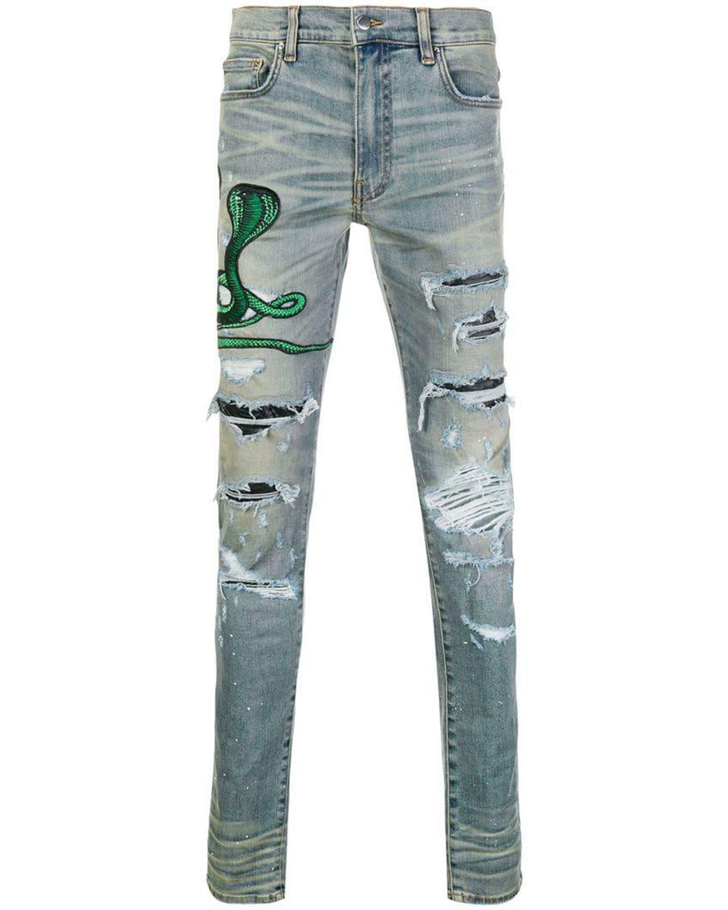 Jeans con strappi decorativi con applicazione serpente da Uomo di Amiri in  Blu | Lyst
