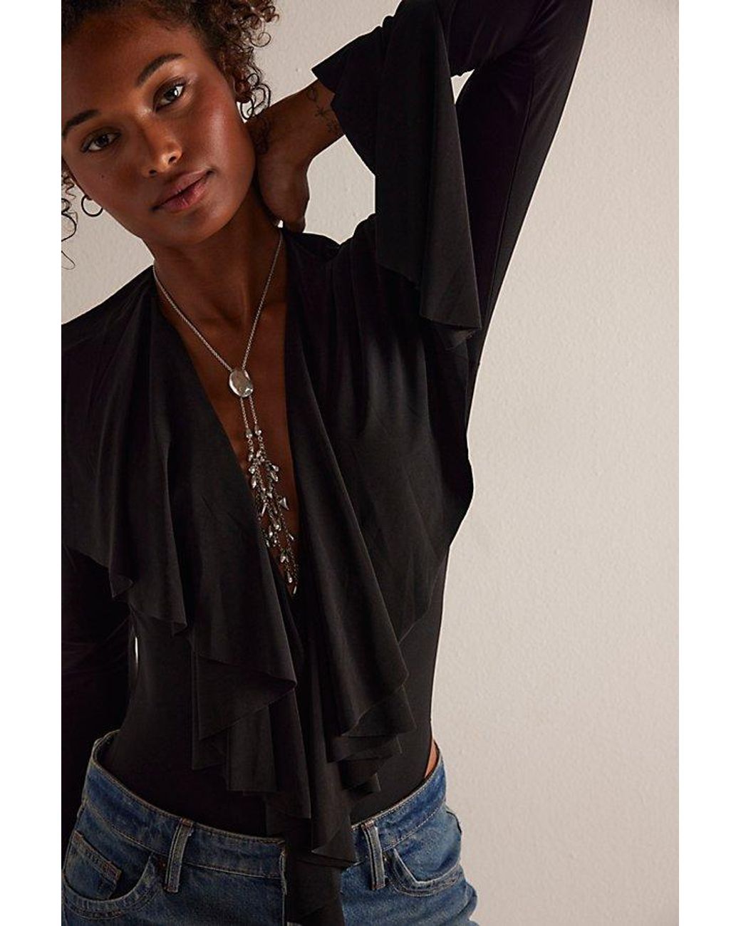 People Ruffling Norma Kamali Long Sleeve Deep V Ruffle Bodysuit in Brown | Lyst