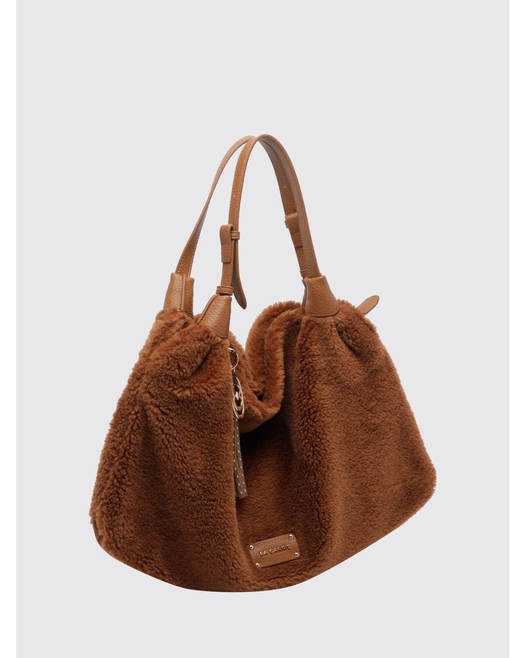 La Carrie Brown Shearling Shoulder Bag With Double Adjustable Handle And Tassels