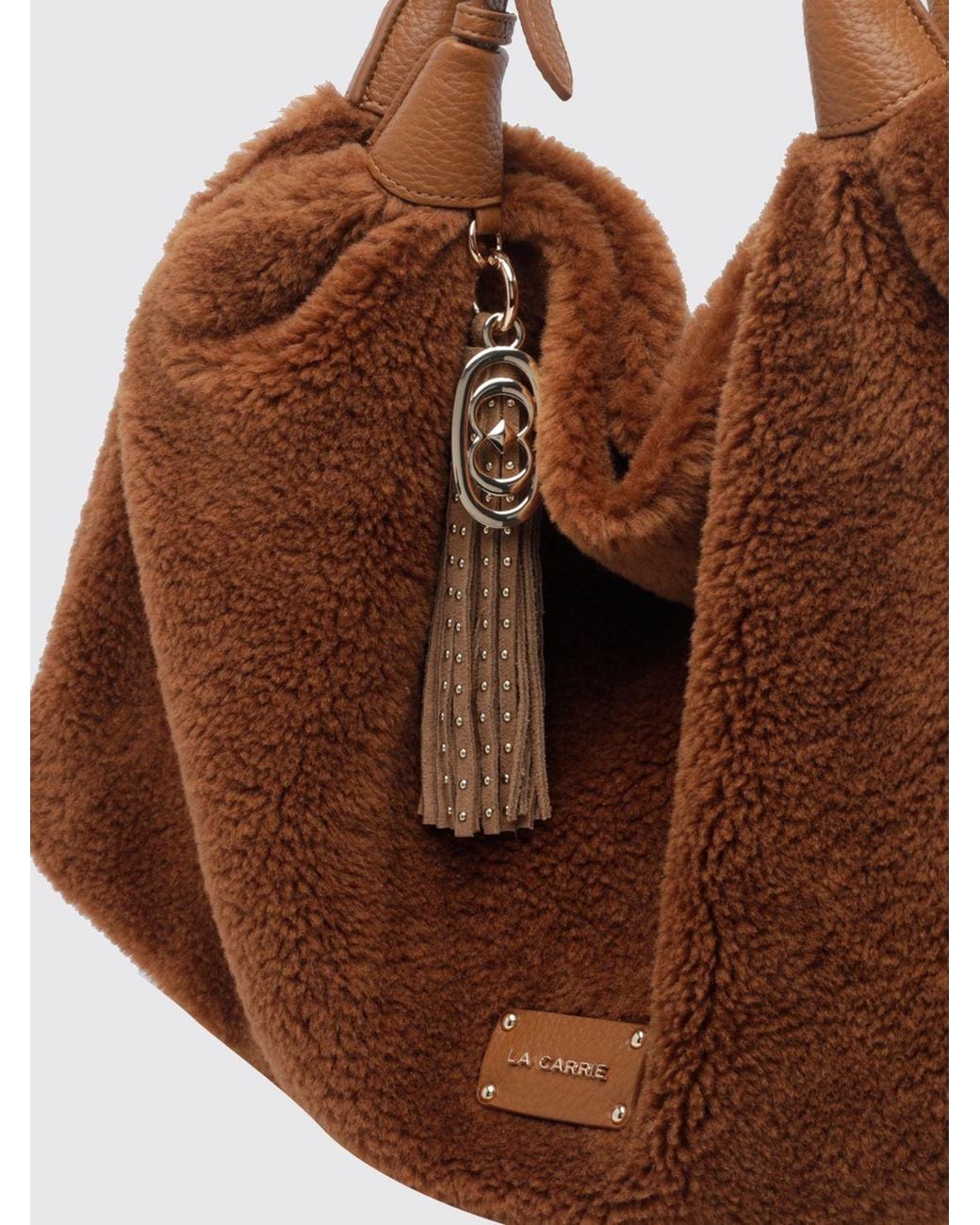 La Carrie Brown Shearling Shoulder Bag With Double Adjustable Handle And Tassels