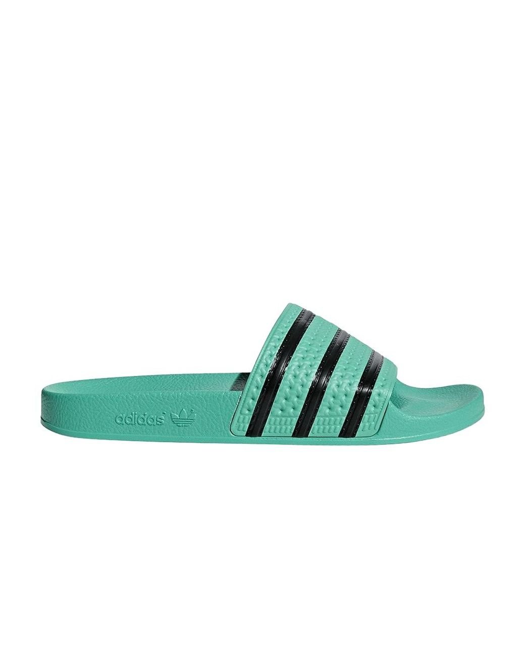 green and black adidas slides