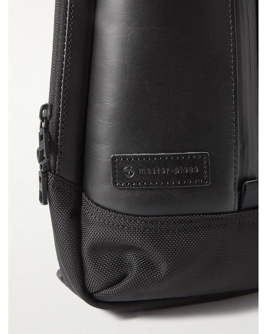 Master Piece Black Slick Logo-Appliquéd Leather And Cordura Barastec Nylon Sling Backpack for men