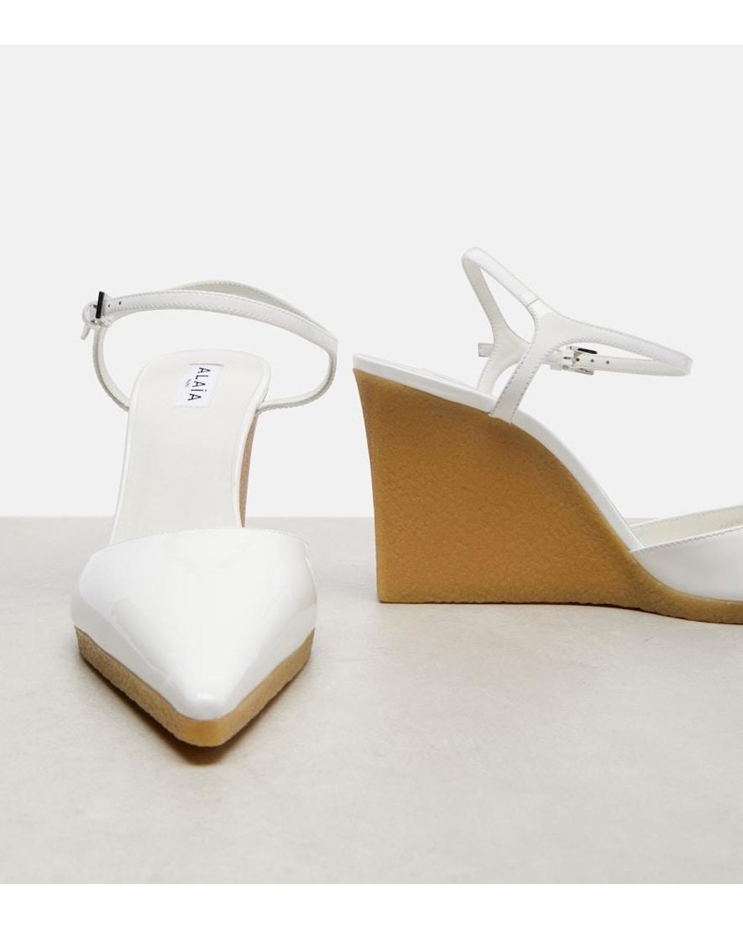 Alaïa White 90 Patent Leather Wedge Slingback Pumps