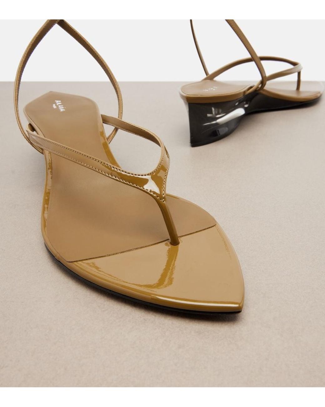 Alaïa Metallic Invisible Patent Leather Wedge Thong Sandals