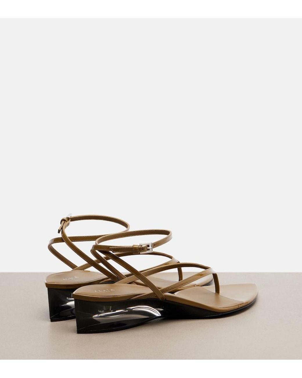 Alaïa Metallic Invisible Patent Leather Wedge Thong Sandals