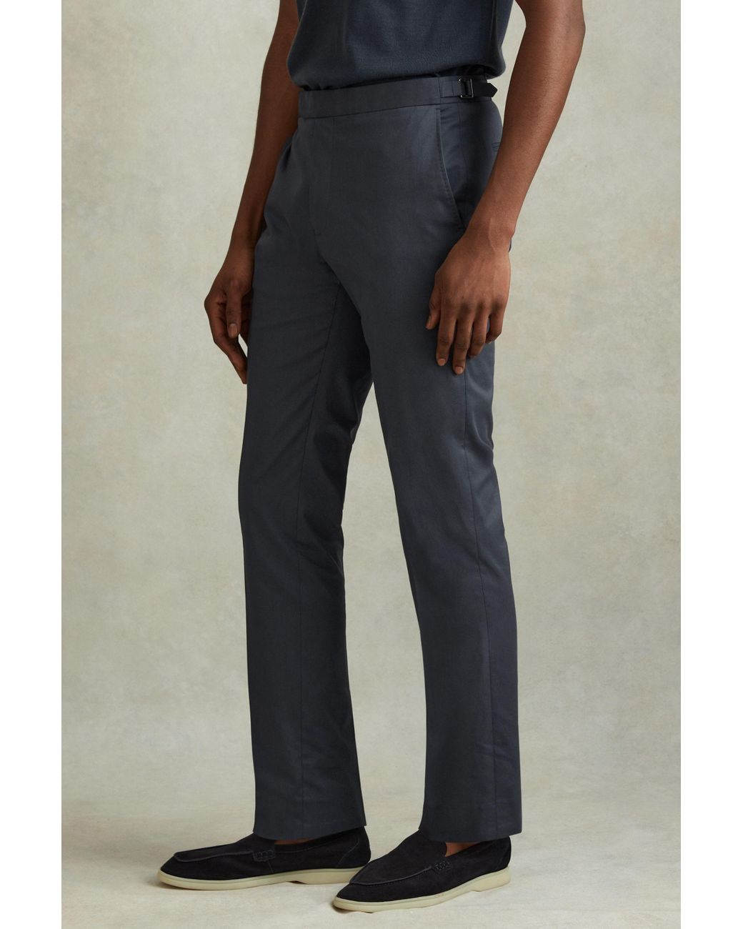 https://cdna.lystit.com/1040/1300/n/photos/reiss/a9ca7f7c/reiss-Airforce-Blue-Crawford-Airforce-Blue-Slim-Fit-Cotton-Blend-Adjuster-Trousers.jpeg