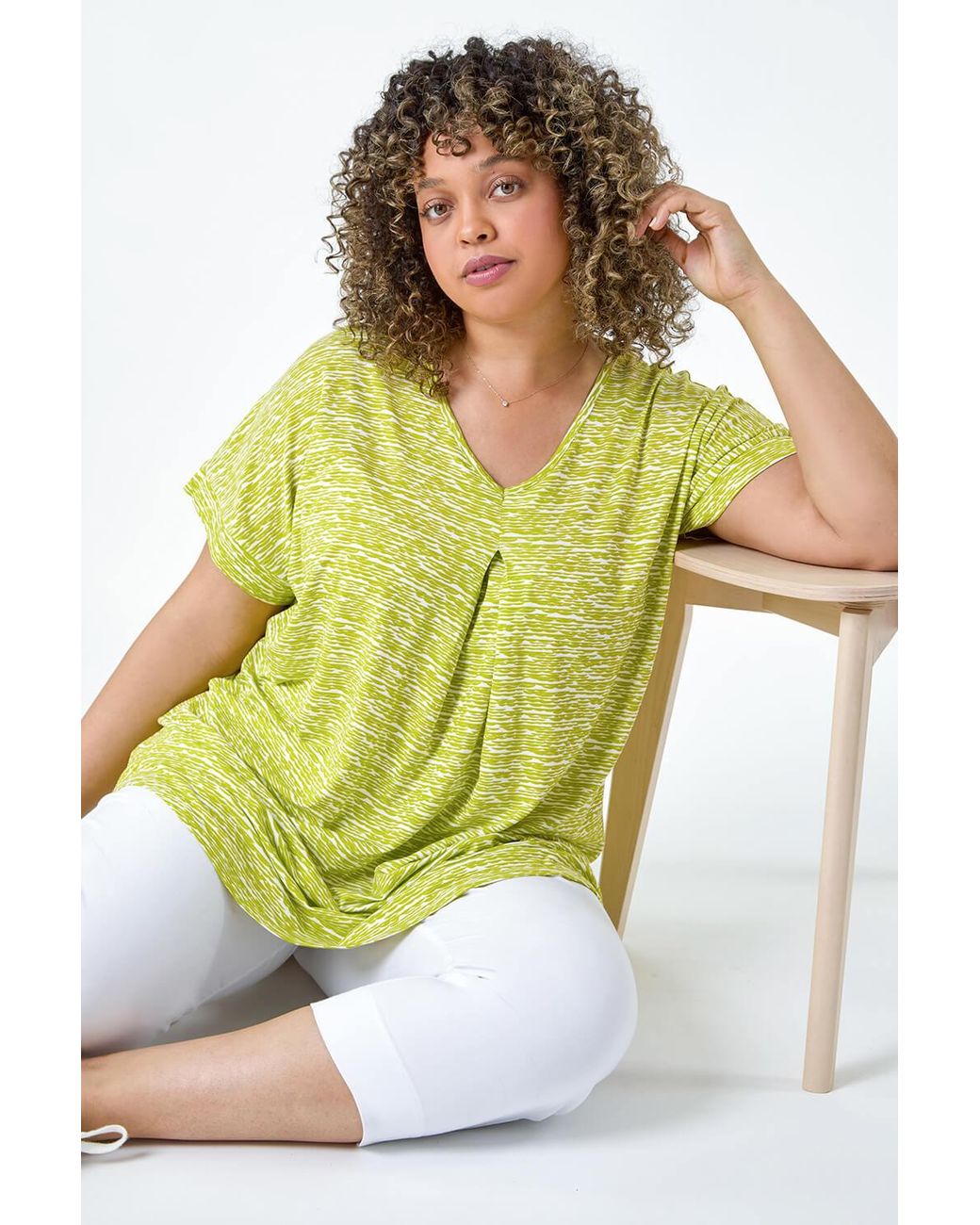 Roman Curve Yellow Pleat Front Printed V-Neck Stretch Top