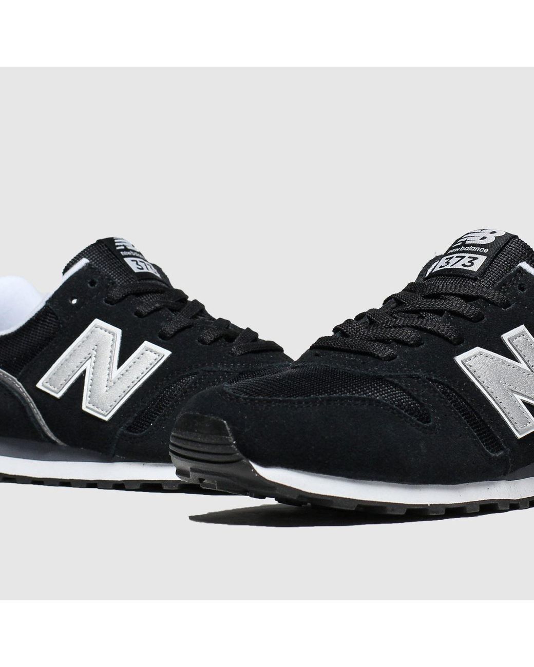 new balance 373 black with silver mink