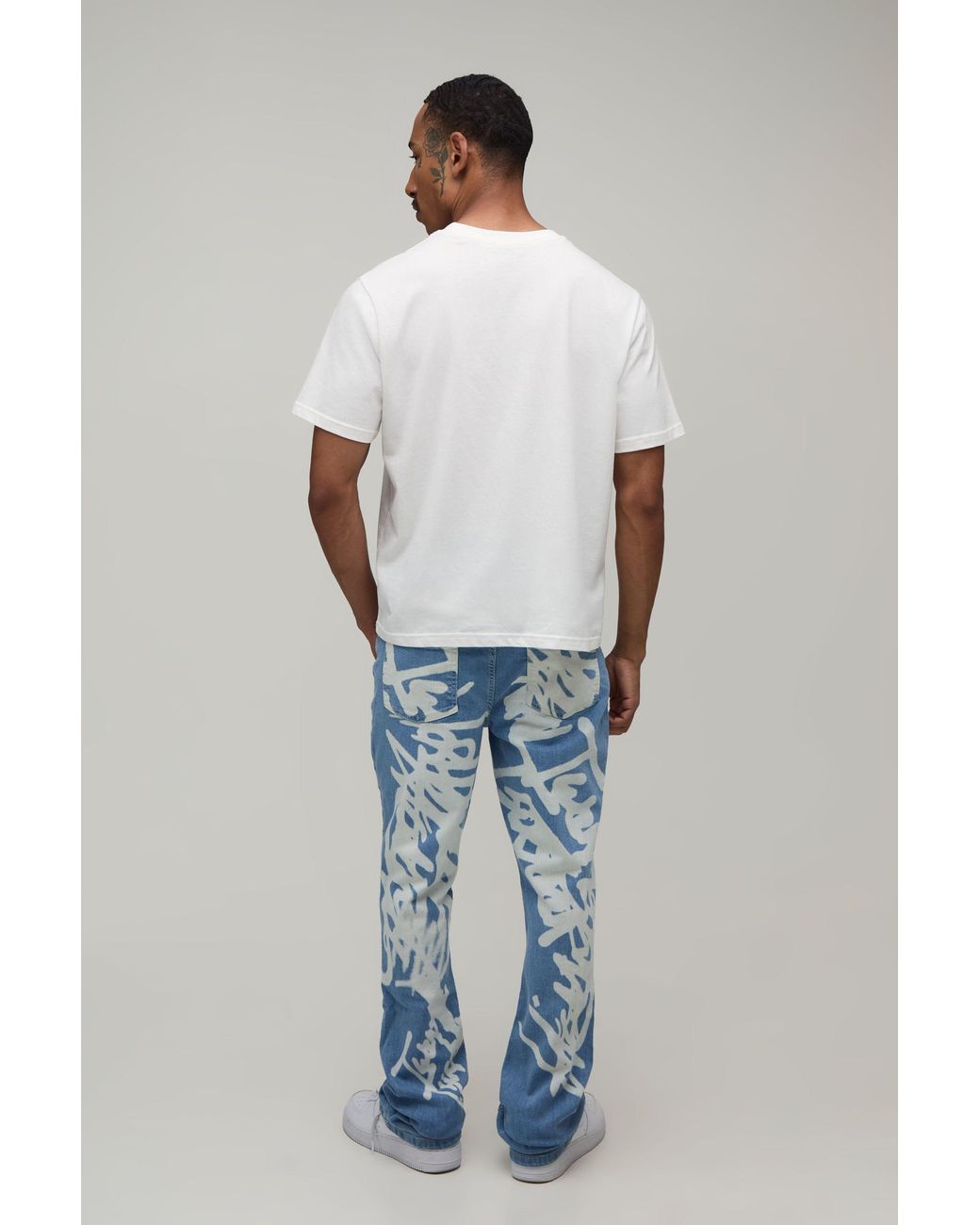 BoohooMAN Blue Stacked Graffiti Print Flared Jeans for men