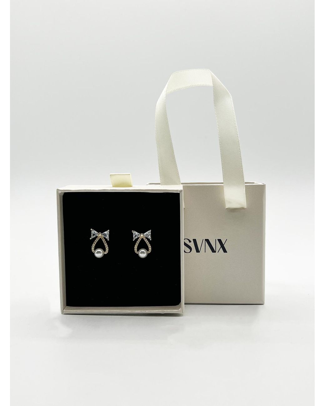 SVNX White Studded Bow Earrings With Hanging Pearl