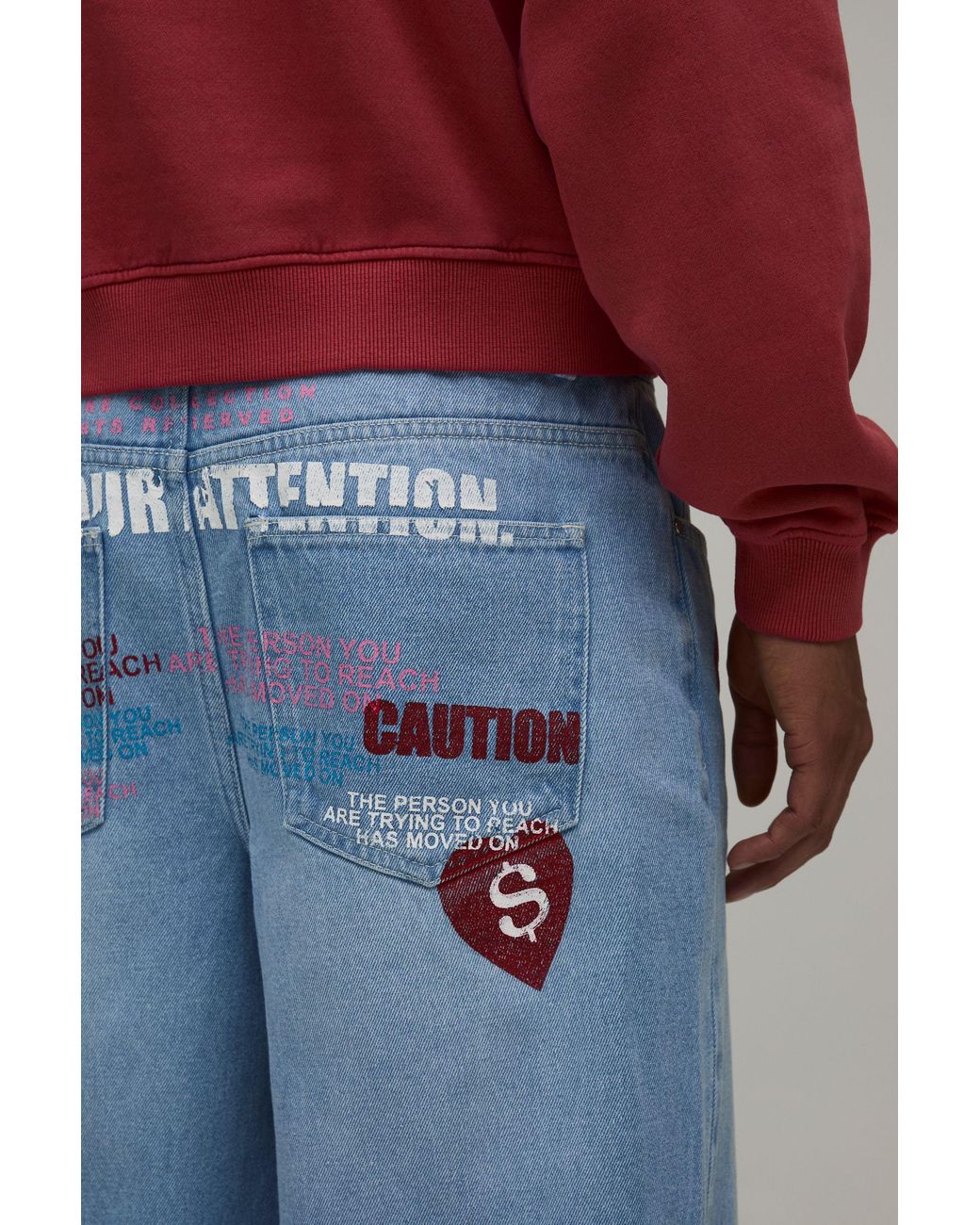 BoohooMAN Blue Caution All Over Graphic Tinted Baggy Fit Jeans for men