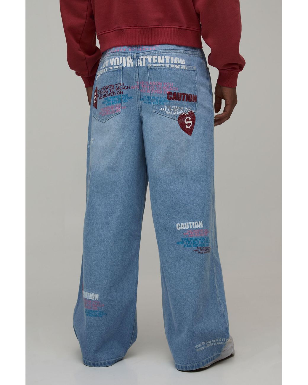 BoohooMAN Blue Caution All Over Graphic Tinted Baggy Fit Jeans for men