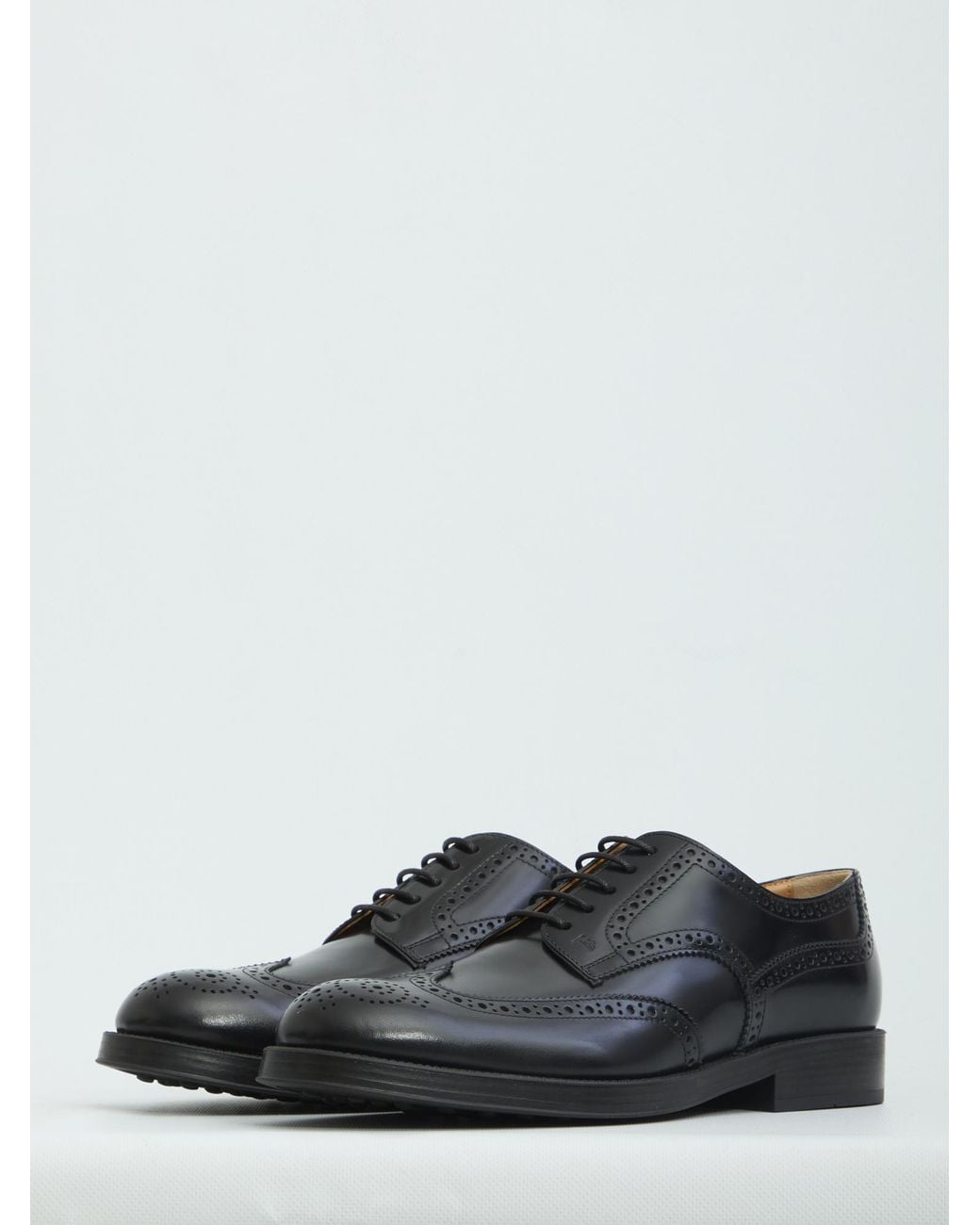 Tod's Black Wingtip Brogue Derby Shoes for men