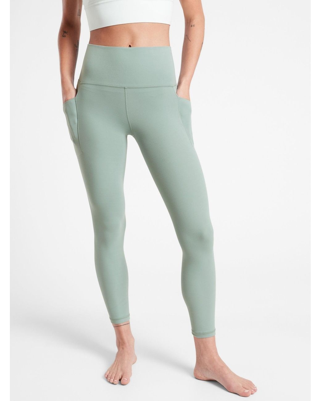 Athleta Salutation Stash 7/8 Tight in Green | Lyst
