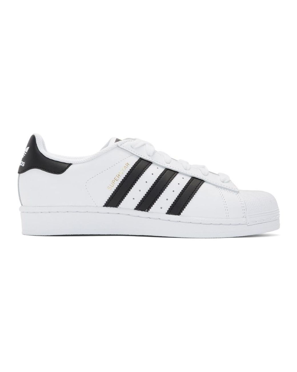 white and black adidas superstar