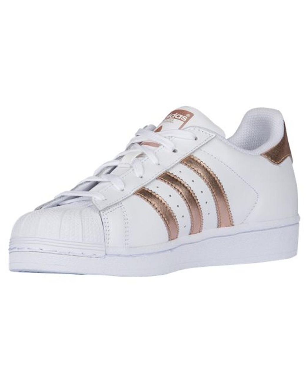 white and gold adidas shell toes
