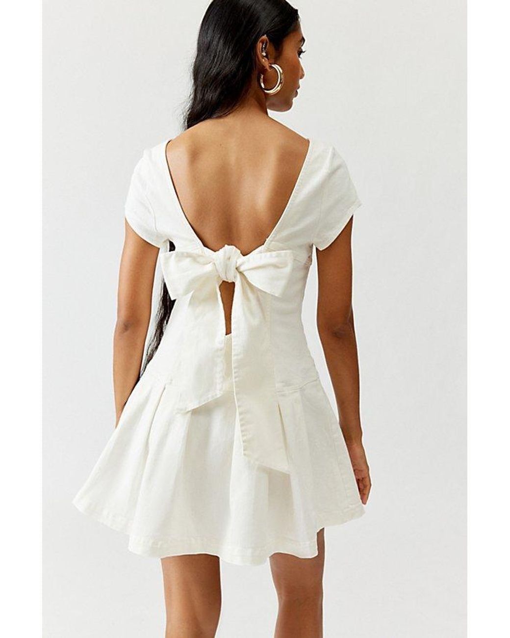 Urban Outfitters Uo Bryan Bow-Back Pleated Drop Waist Denim Mini Dress in  White | Lyst