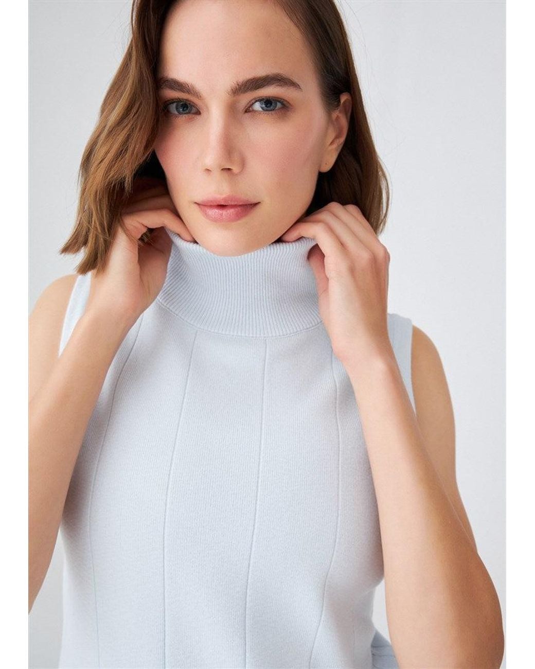 Peraluna Blue Slim Fit Sleeveless Turtle-Neck Blouse