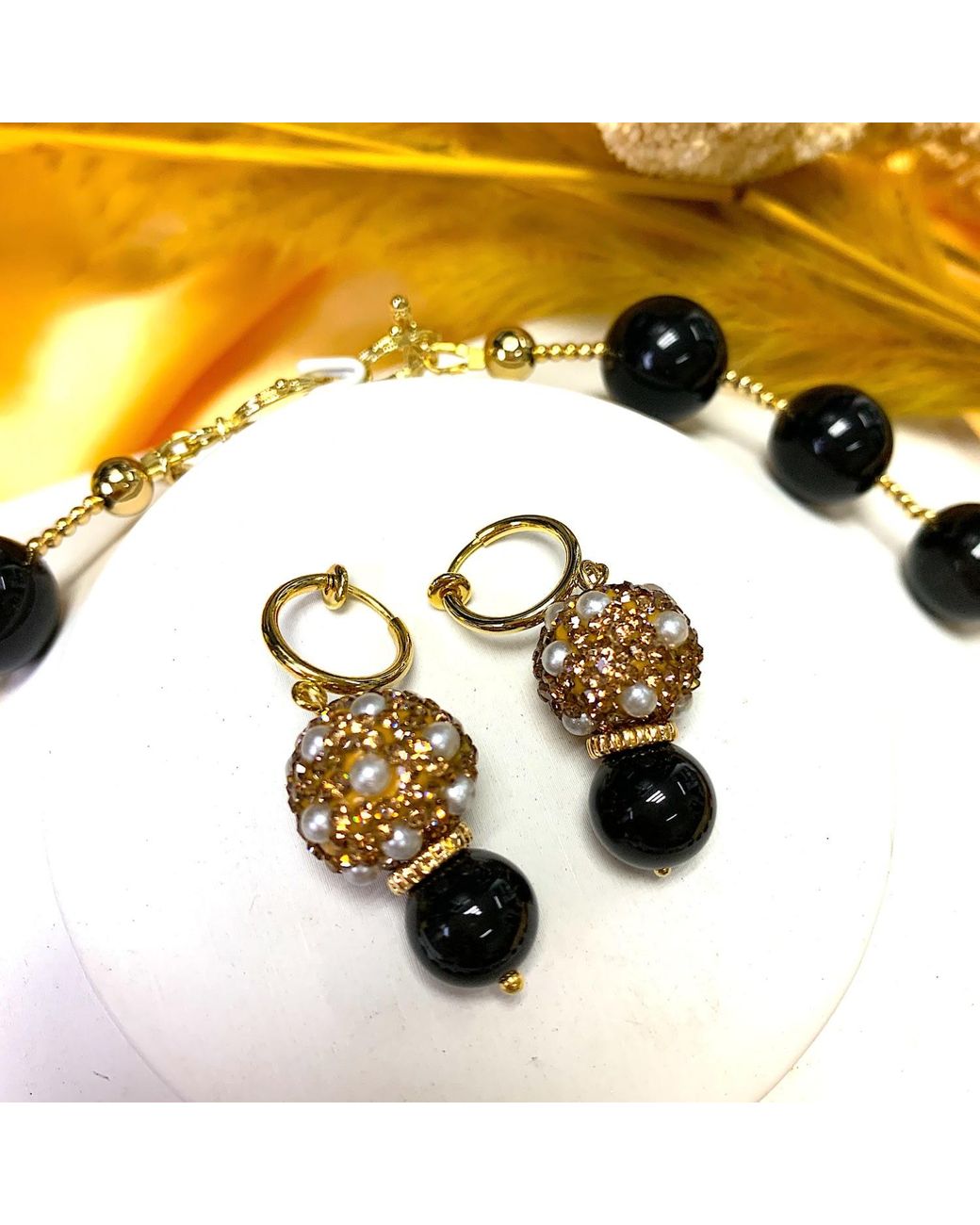 Farra Metallic Round Rhinestones Bordered Pearls With Obsidian Clip On Earrings