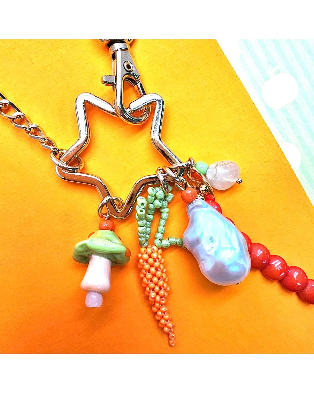 Farra Metallic Baroque Pearl Bamboo Coral And Handcrafted Carrot Bag Charm