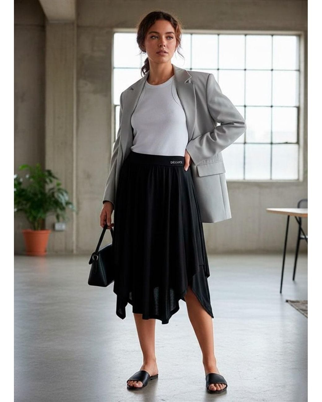Conquista Black Asymmetric Midi Skirt With Flowing Silhouette