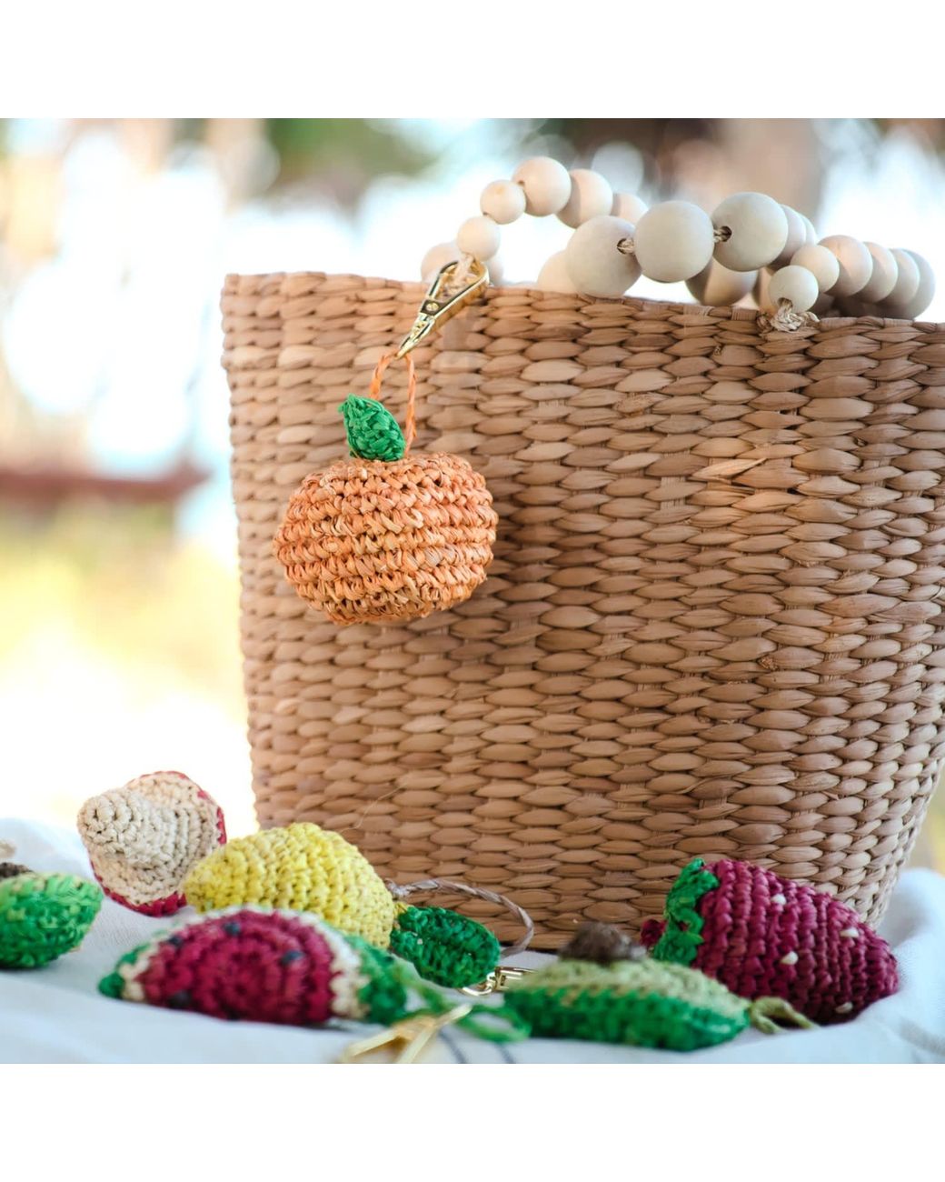 LIKHÂ Metallic Citrus Burst Raffia Bag Charm