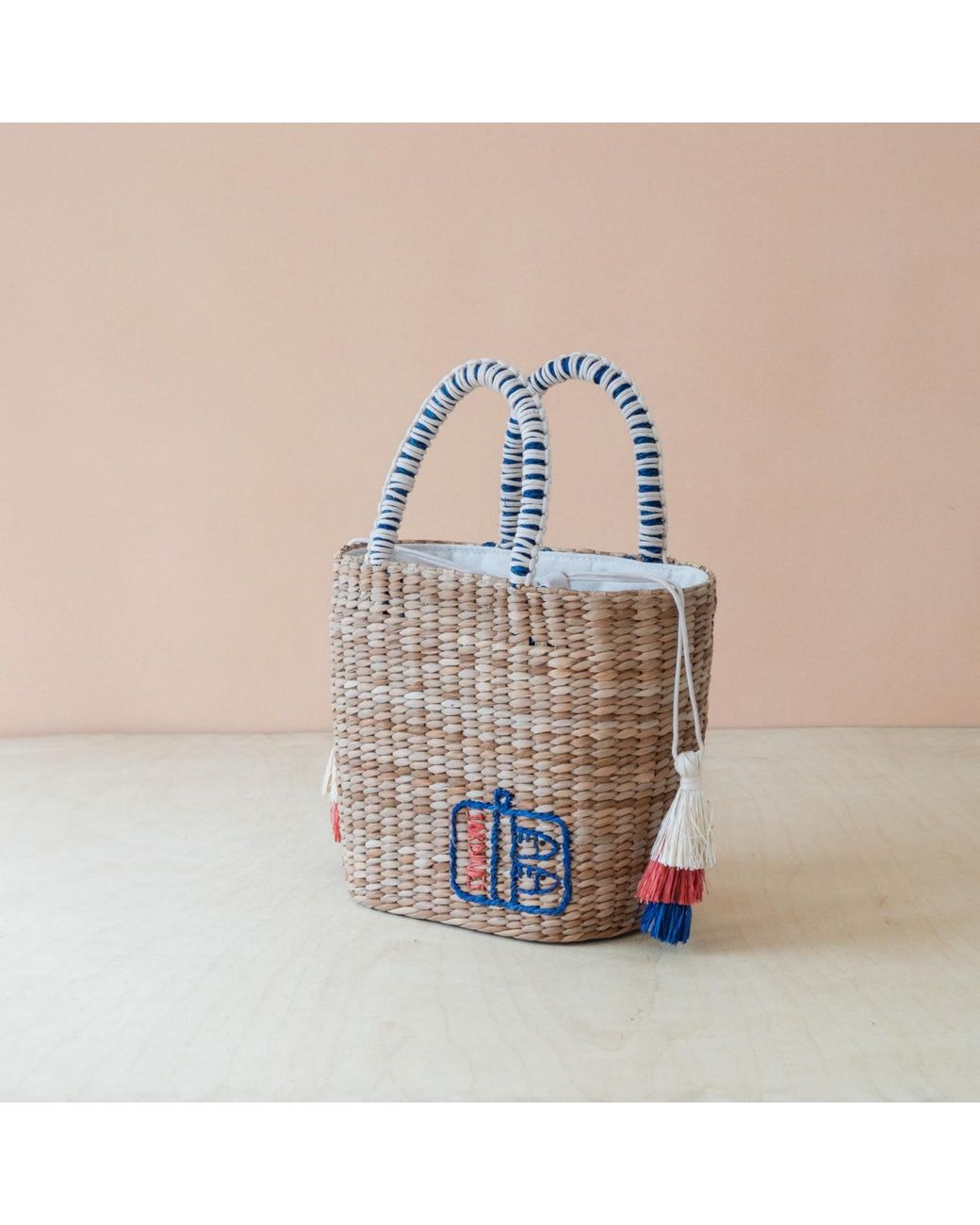 LIKHÂ Blue Neutrals Handwoven Seagrass Sardine Can Tote Bag With Tassels