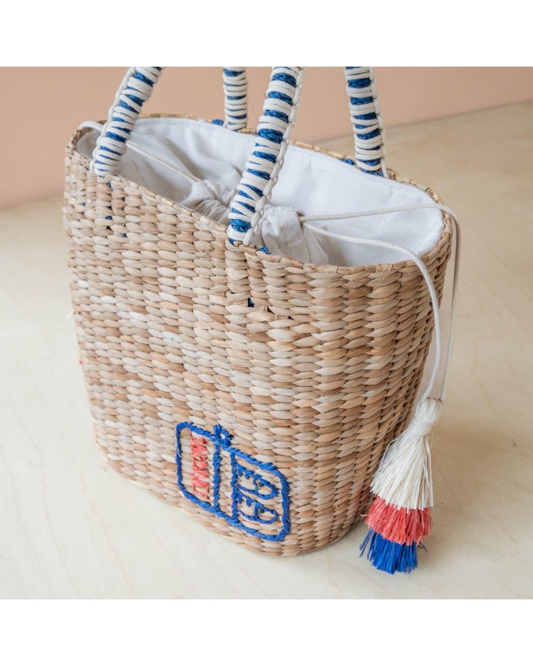 LIKHÂ Blue Neutrals Handwoven Seagrass Sardine Can Tote Bag With Tassels